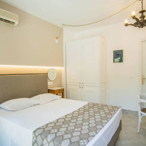 Nami Hotel Suites Double Superior Room double bed, bedside tables and amenities
