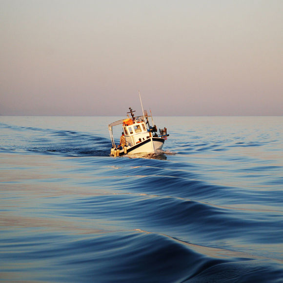 A small boat sailing at the sea