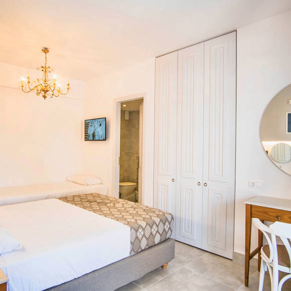 Nami Hotel Suites Double Superior Room bedroom with a double bed, a single bed and amenities