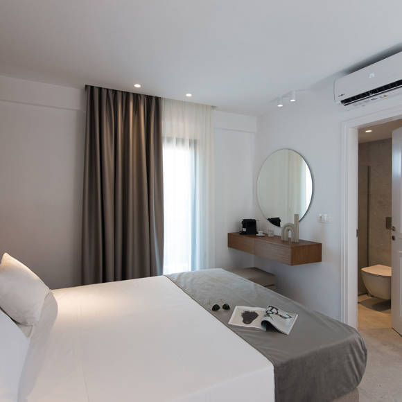 Nami Hotel Suites Deluxe Room bedroom and bathroom door