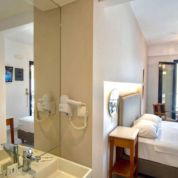 Nami Hotel Suites Double Superior Room washbasin and the double bed in the background