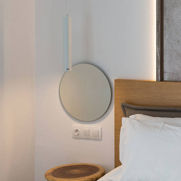 Nami Hotel Suites Deluxe Room small bedside table and round mirror