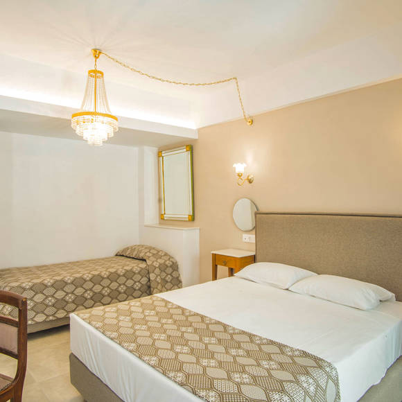 Nami Hotel Suites Double Superior Room bedroom with a double bed and a single bed