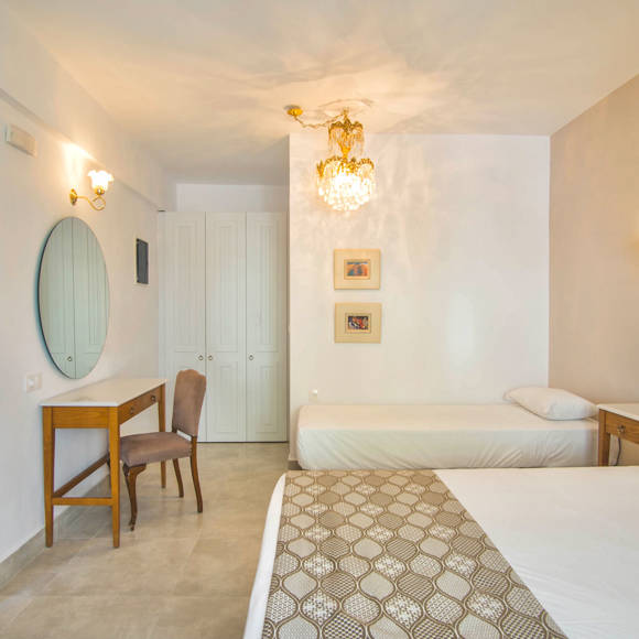 Nami Hotel Suites Double Superior Room bedroom with a single bed and a double bed